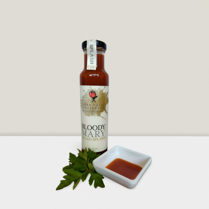 Bottle of Bloody Mary salad splash with sauce dish.